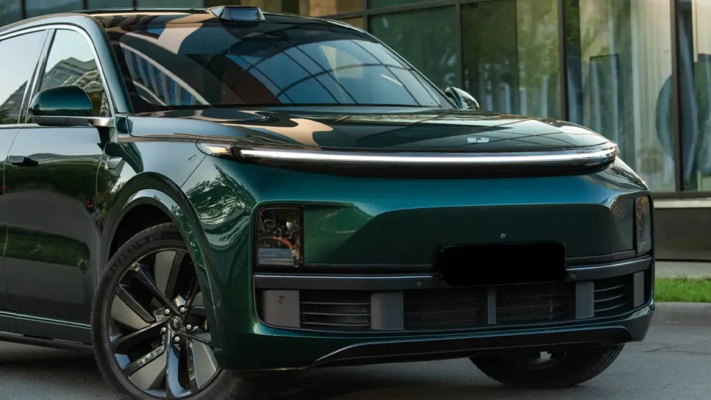 "Chinese cars with futuristic styling: front view of a green electric SUV featuring sleek headlights and aerodynamic design."