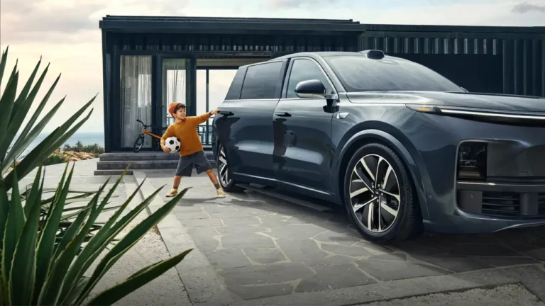 A child with a soccer ball opening the door of a modern electric SUV parked in front of a minimalist house