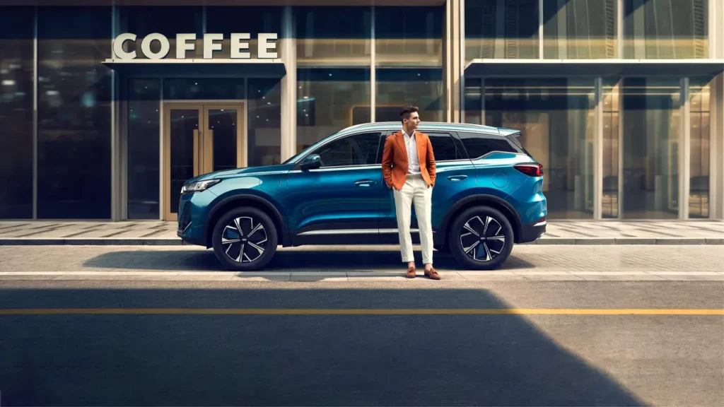 "Stylish man standing next to a modern Chinese car in an urban setting, showcasing the sleek design of new Chinese cars."