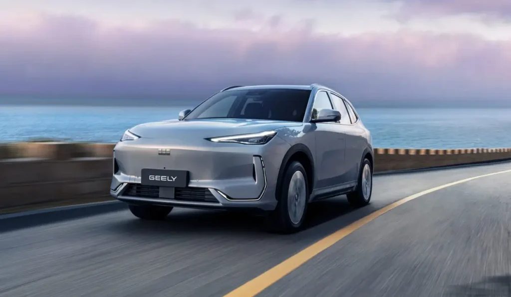Geely Galaxy E5 in motion on a coastal road, emphasizing electric efficiency and fluid body lines.