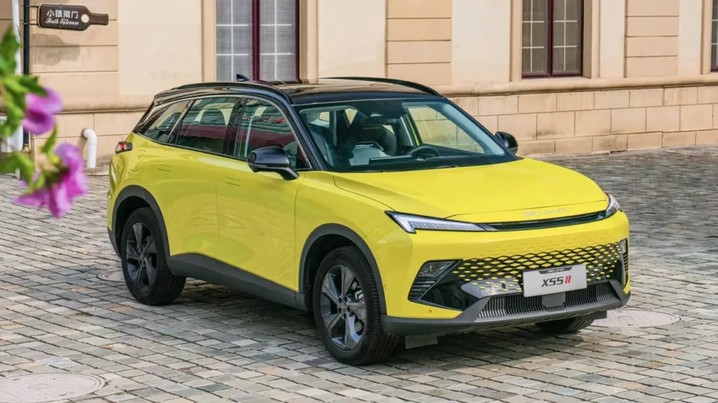 Yellow BEIJING X55 II, front-left view near a building