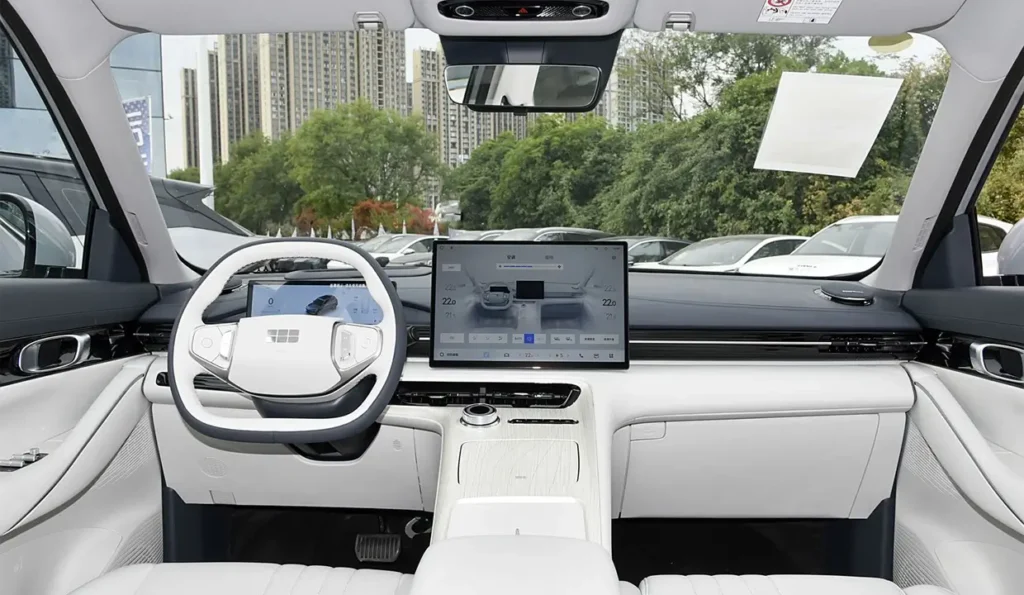 Interior of the Geely Galaxy E5 with steering wheel, main screen, and panoramic visibility from the driver’s