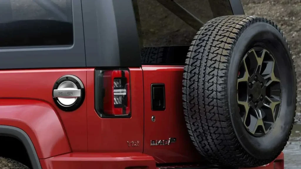 Close-up of BAIC BJ40 Plus rear: spare tire, taillight, and fuel cap with metallic finish.