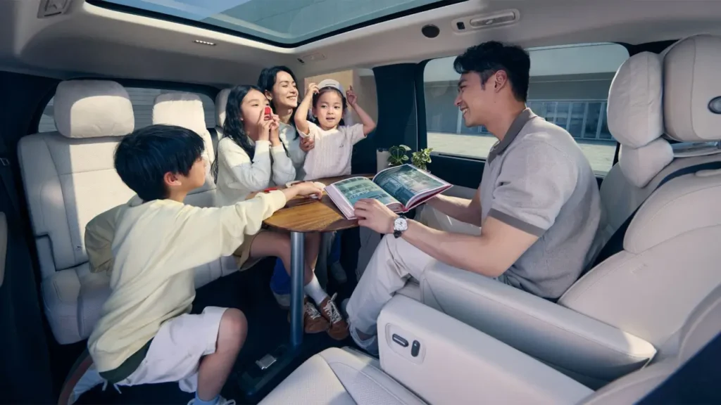 Li MEGA interior with family enjoying time around a fold-out table