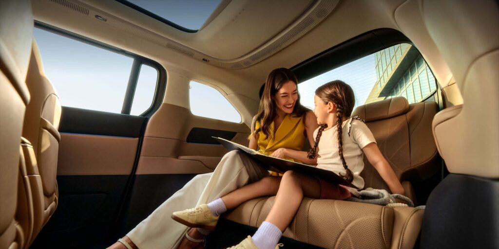 Mother and daughter reading inside Xpeng X9