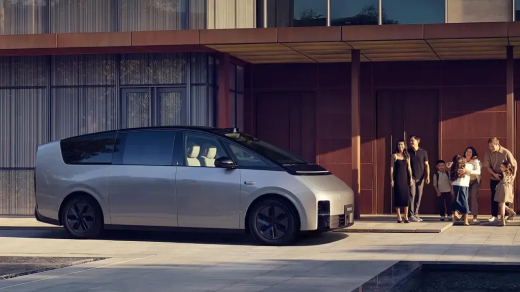Li MEGA parked outside a modern home with multi-generational family nearby