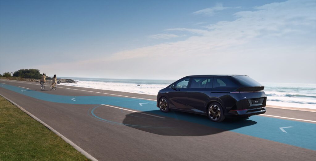 Xpeng X9 driving by the sea with autopilot active